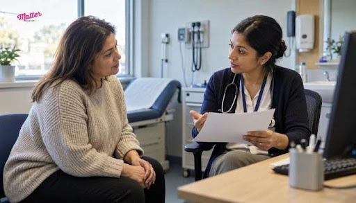 Female doctor talking with a female patient who is holding a medical report